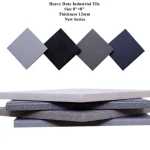 Stacked acid resistant vitrified tiles in gray-to-black shades, featuring a sleek industrial look.